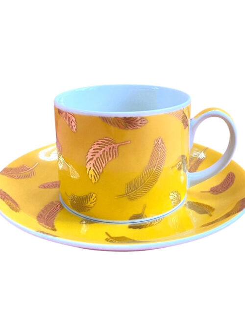 Yellow tea and coffee cup with a saucer